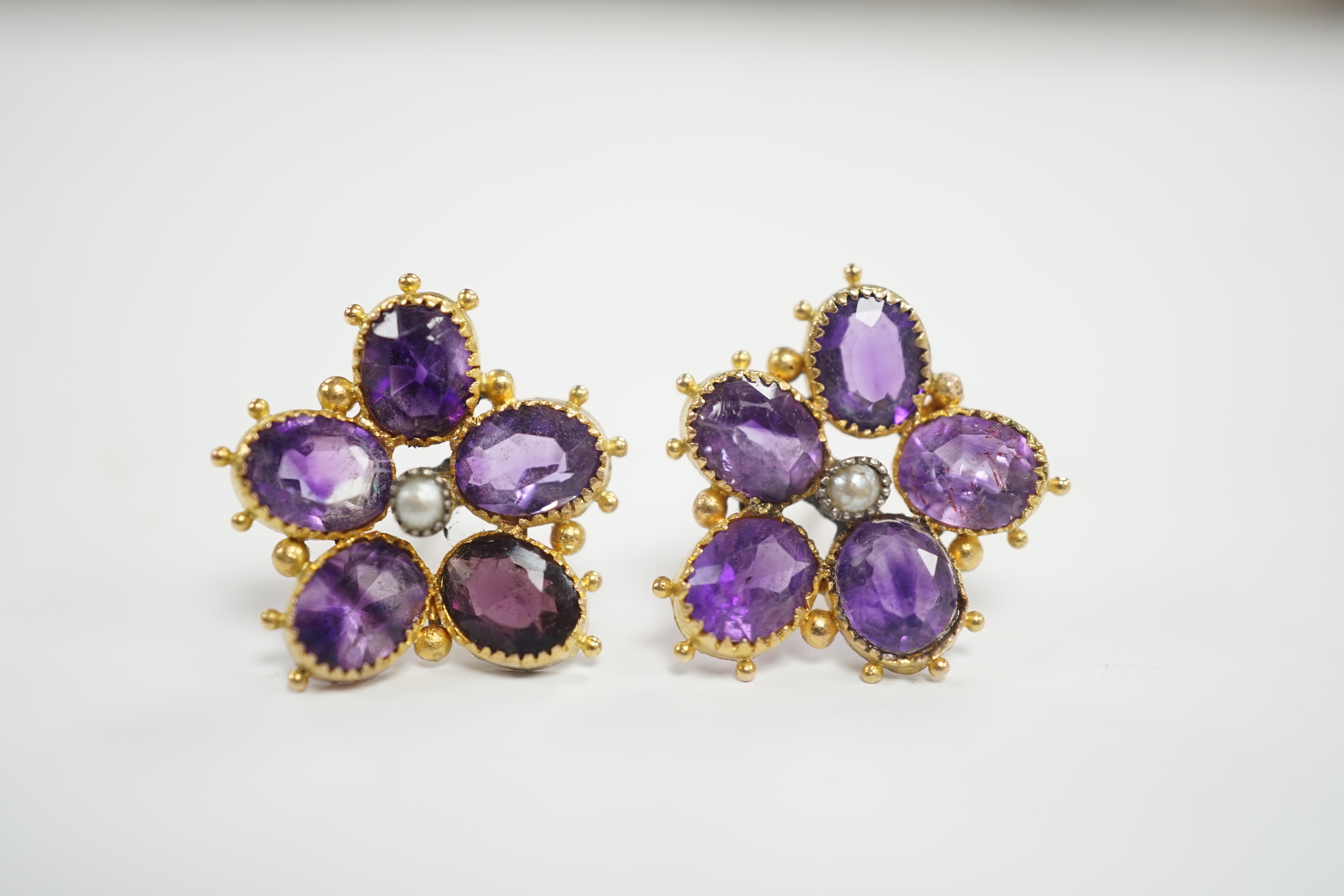 A pair of yellow metal, amethyst and seed pearl set flowerhead ear studs, 18mm, gross weight 4 grams.